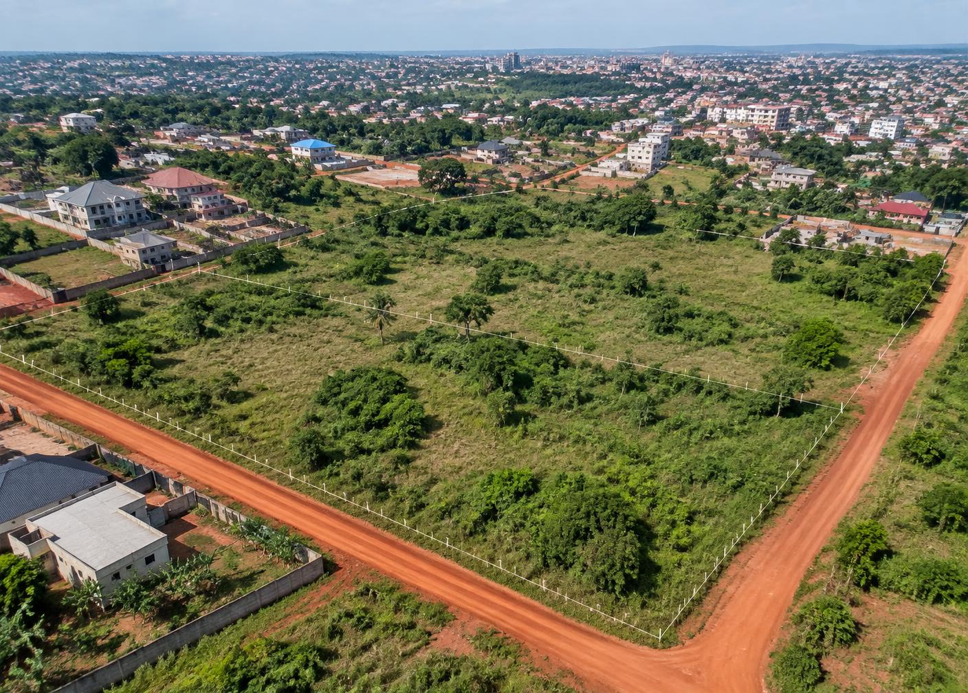 Aerial view of an undeveloped parcel beside an African city